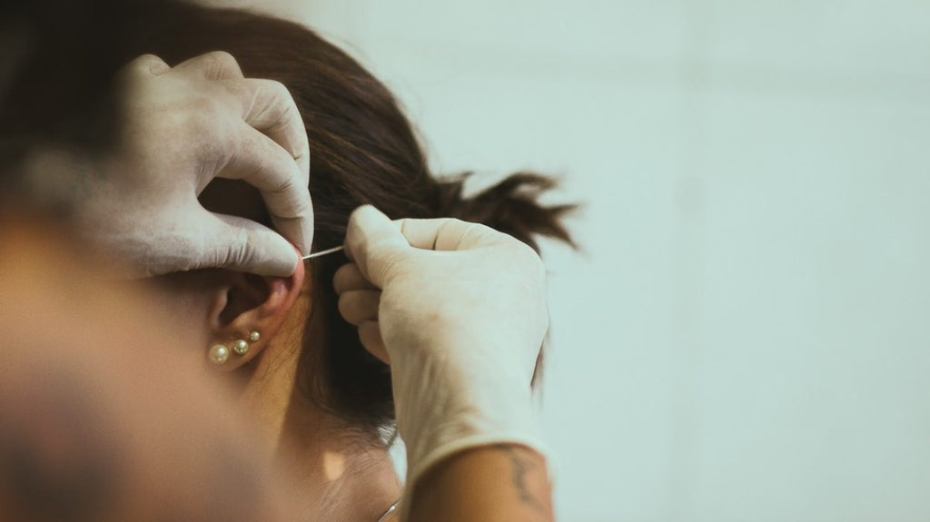 Woman being pierced